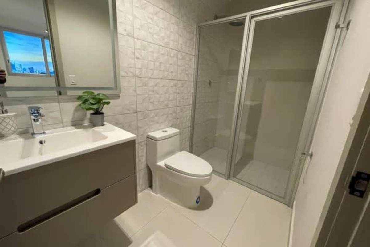 Contemporary bathroom featuring glass shower, large mirror, and elegant vanity in PH Via Brasil 57 Panama