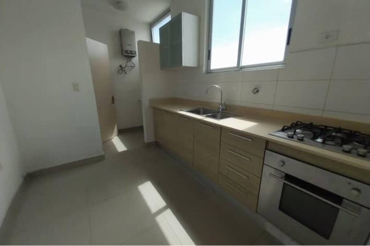 Enclosed kitchen with granite counters, stove oven and window PH Firenze Tower Panama City