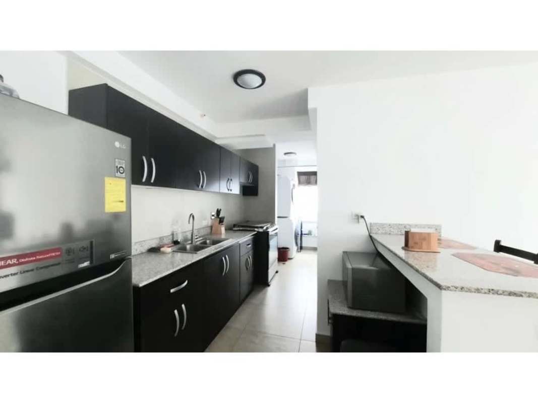 Bright living dining space with balcony views, modern tile flooring, open kitchen PH Torre 100 Carrasquilla Panama