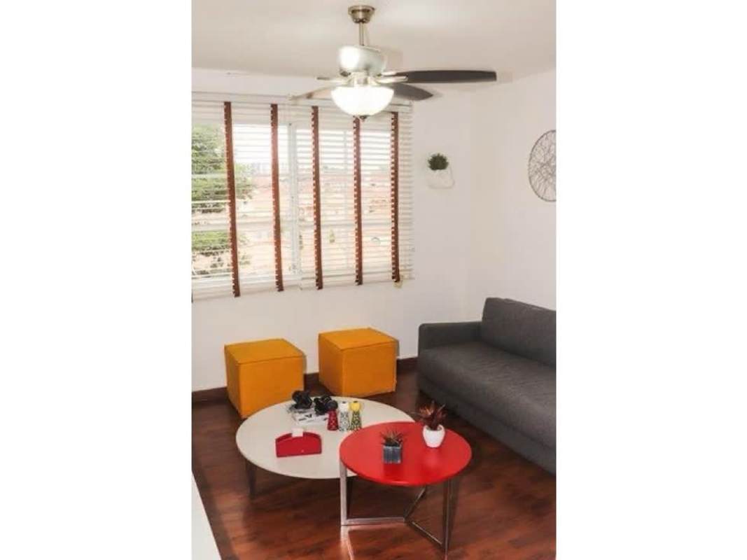 Modern living room with striped accent wall and wood floors luxury house Altos de Panamá