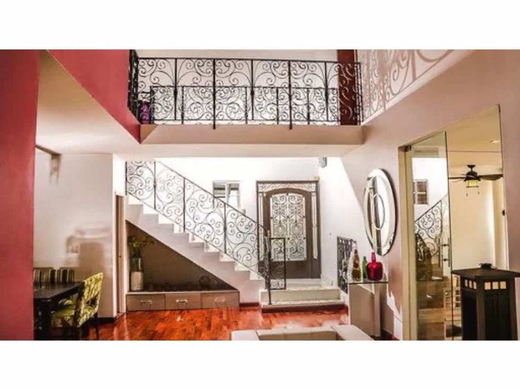 Foyer with wrought iron staircase, balcony and elegant decor luxury home for sale Altos de Panamá