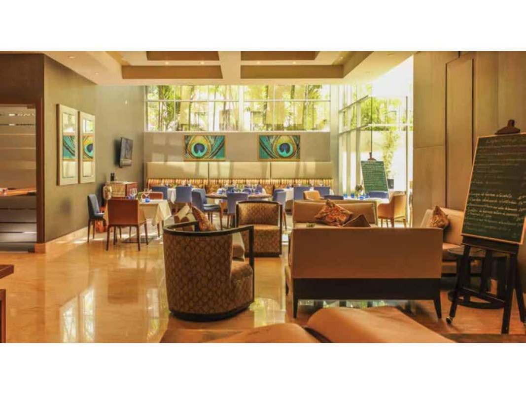 Contemporary restaurant dining space with large windows, wall art and stylish seating in PH BICSA