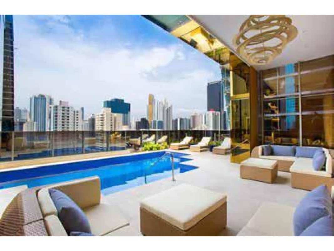 Infinity rooftop pool with modern lounge seating and skyline views at PH BICSA