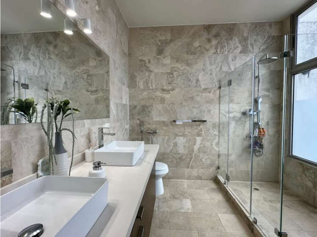 Modern bathroom with double sinks, large mirror, walk-in shower PH Aqualina Punta Pacifica