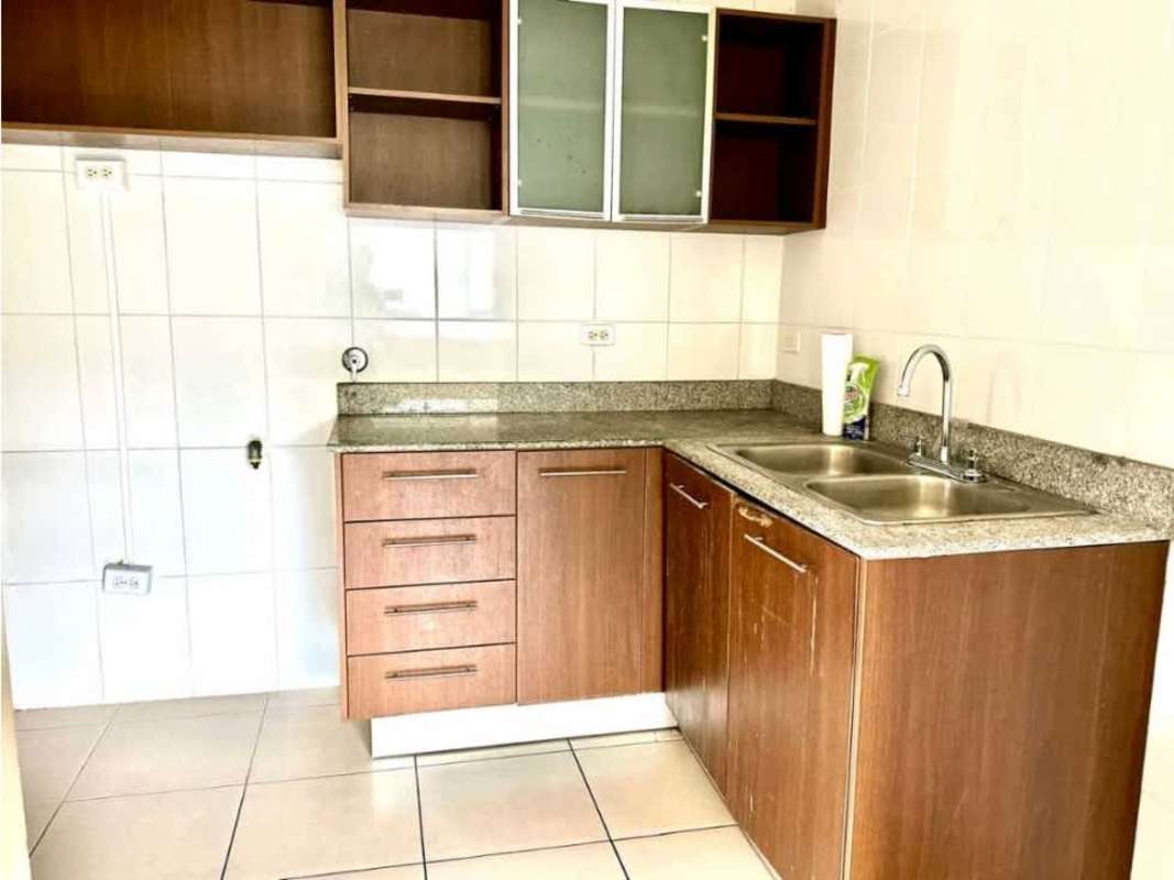 Kitchen with wooden cabinetry and granite countertops PH Mallorca Park Village Los Andes