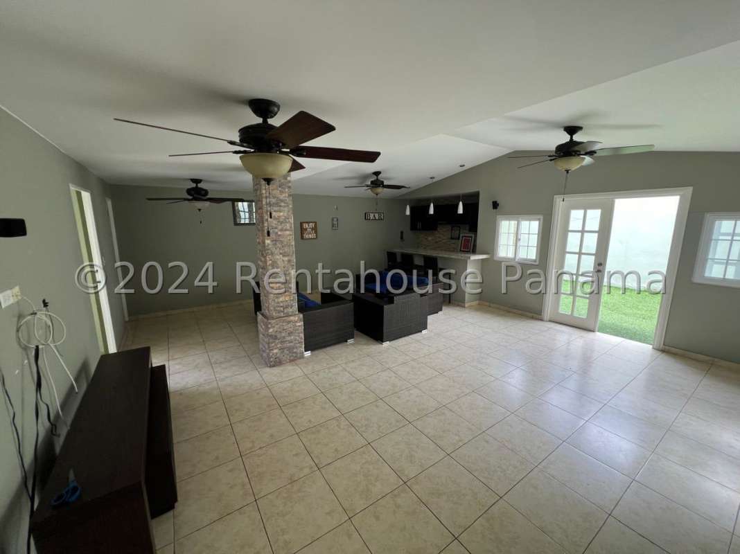 Bright living room with tile floors, staircase and ceiling fan PH Villa de las Azores Panama City