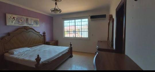 Spacious master bedroom wooden wardrobe windows air conditioning luxury home Colon Panama