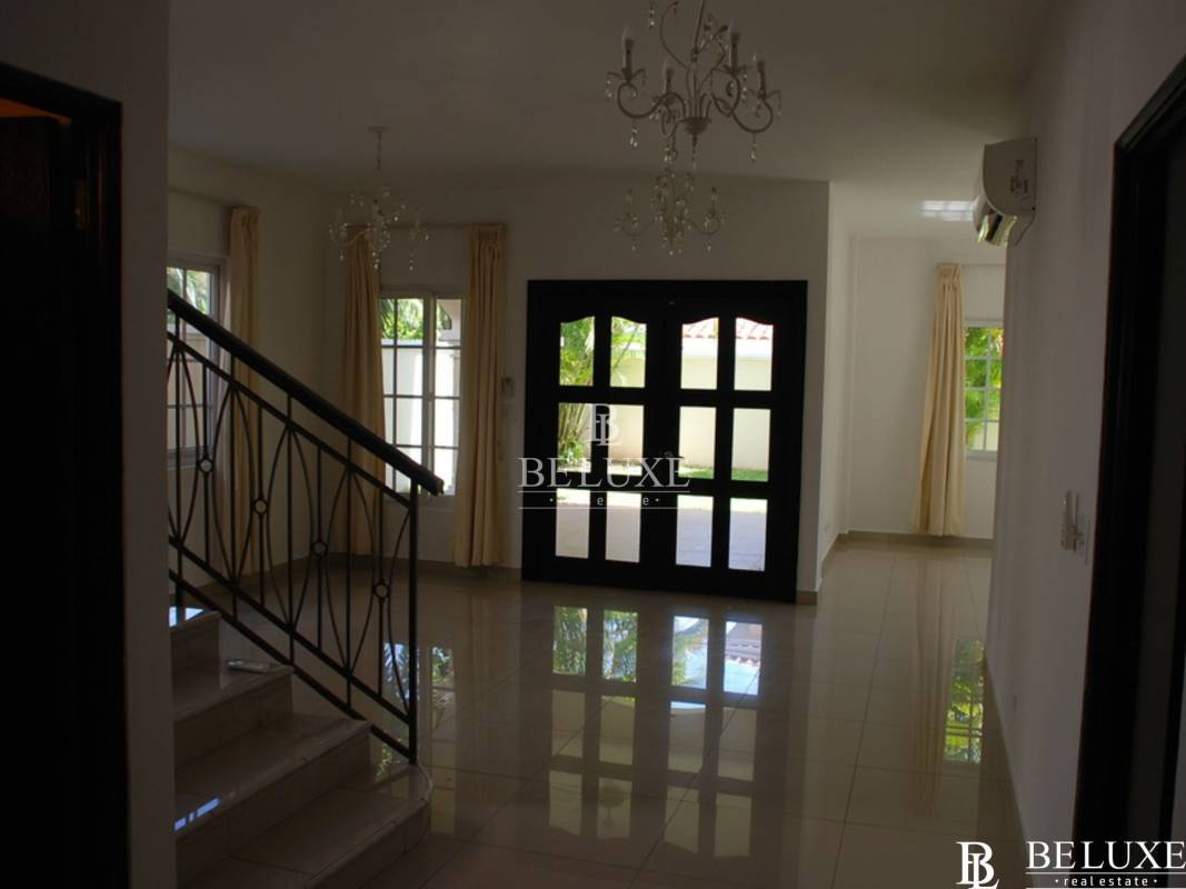 Open plan dining and living area with porcelain floors in Villa Valencia Costa Sur Panama