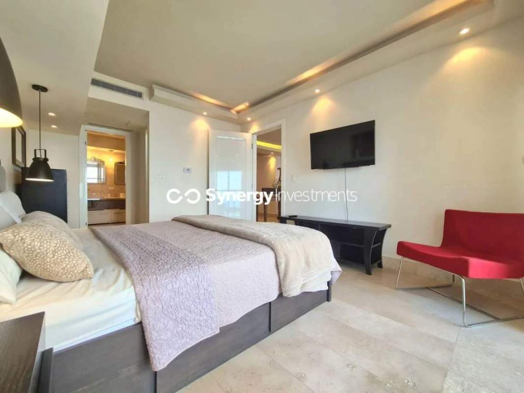 Furnished master bedroom with large windows and ocean views in Yoo Panama Panama City