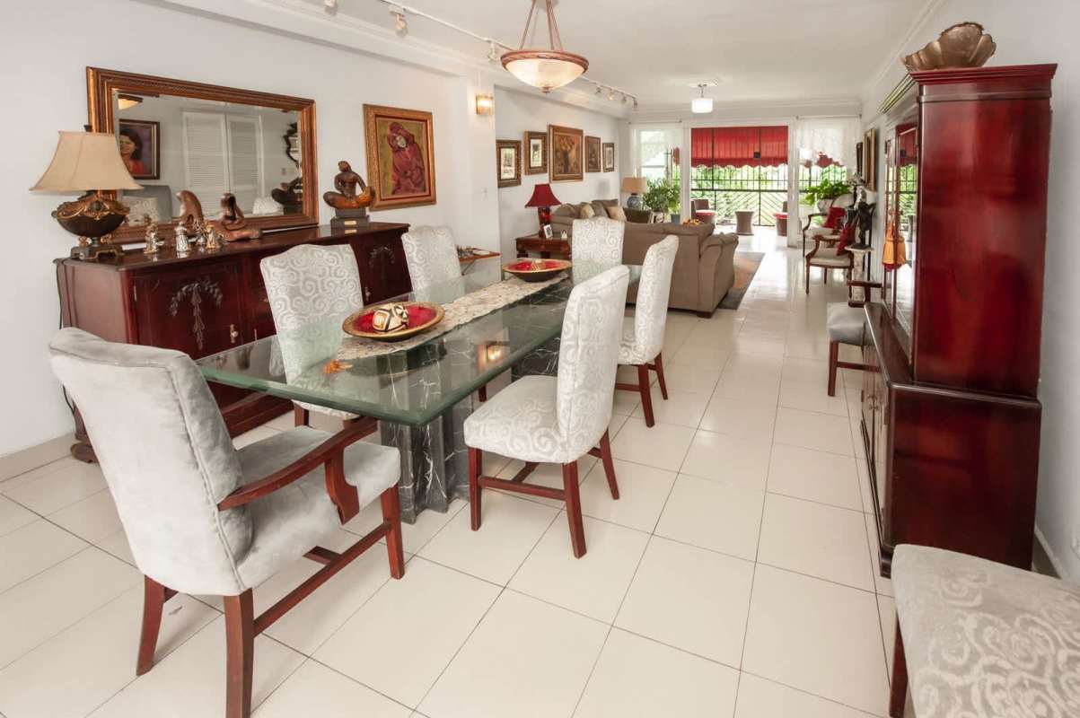 Open plan living dining with glass table, sofa set, window light at PH Majurova Panama
