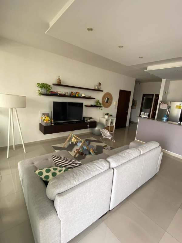 Bright living room with access to balcony overlooking Panama City at PH Quadrat San Francisco