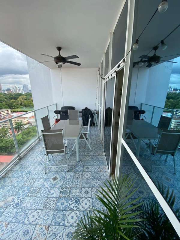 Balcony with glass railing and panoramic city view in PH Quadrat Panama City