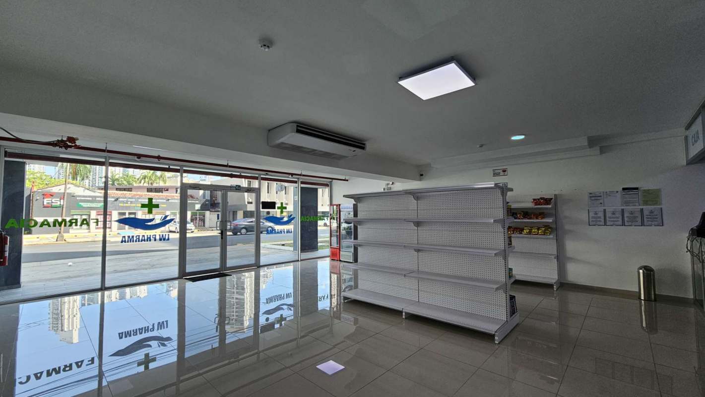 Empty open-plan commercial retail or office space with white tiles and recessed lighting on Vía España