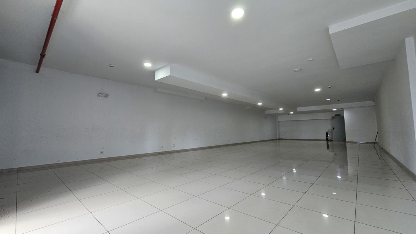 Open white-tiled commercial unit with recessed lights in Panama City