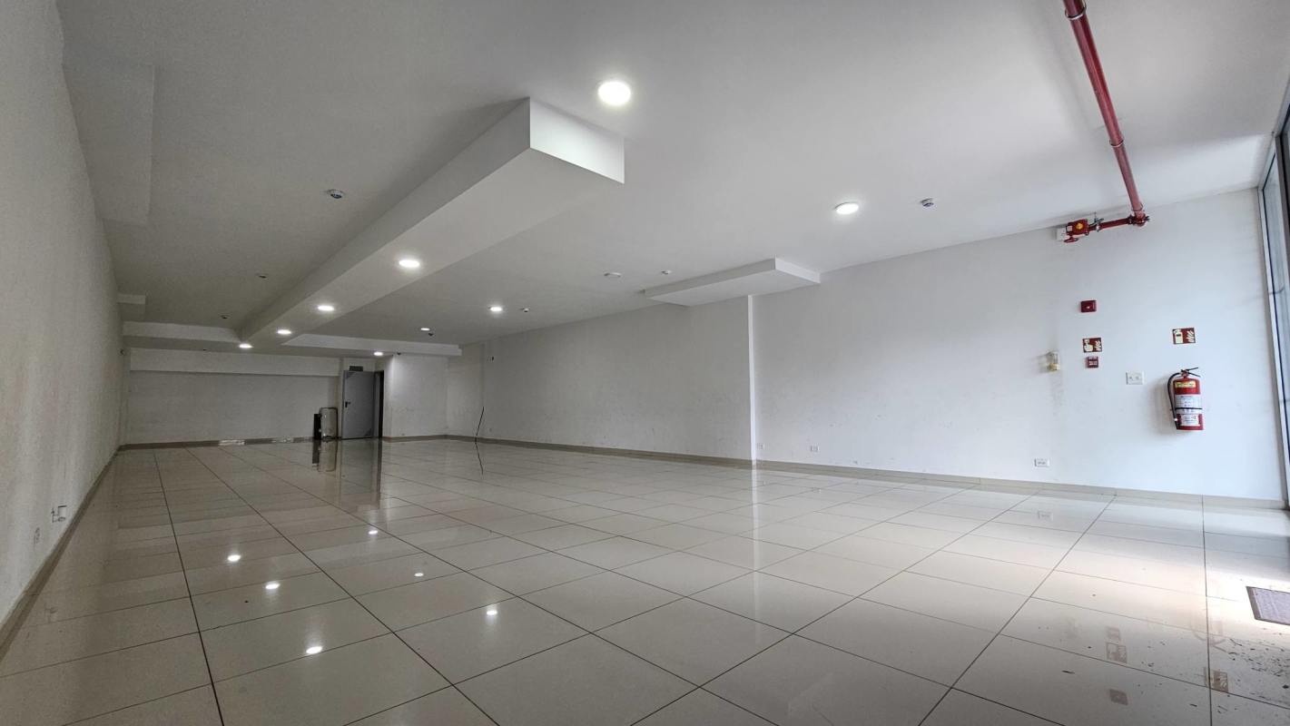 Open floor plan commercial space with white tiles and lighting in Panama City