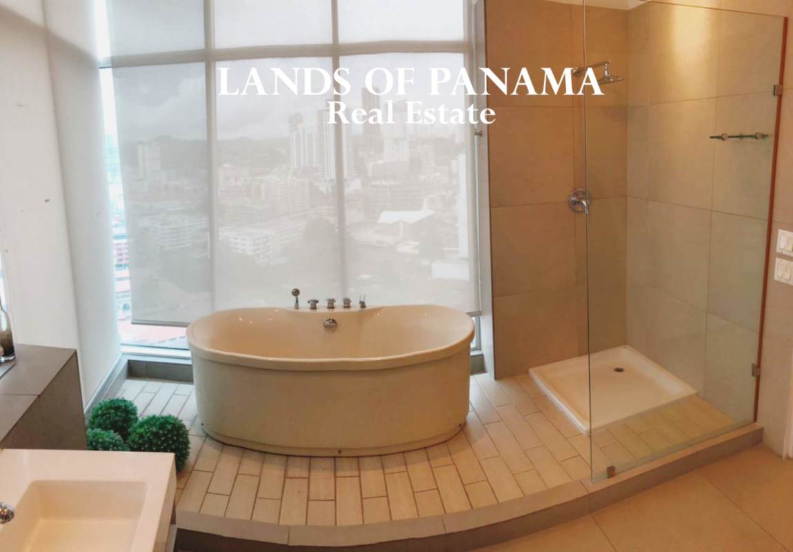 Modern bathroom with freestanding tub and city views at PH Yacht Club Tower Panama