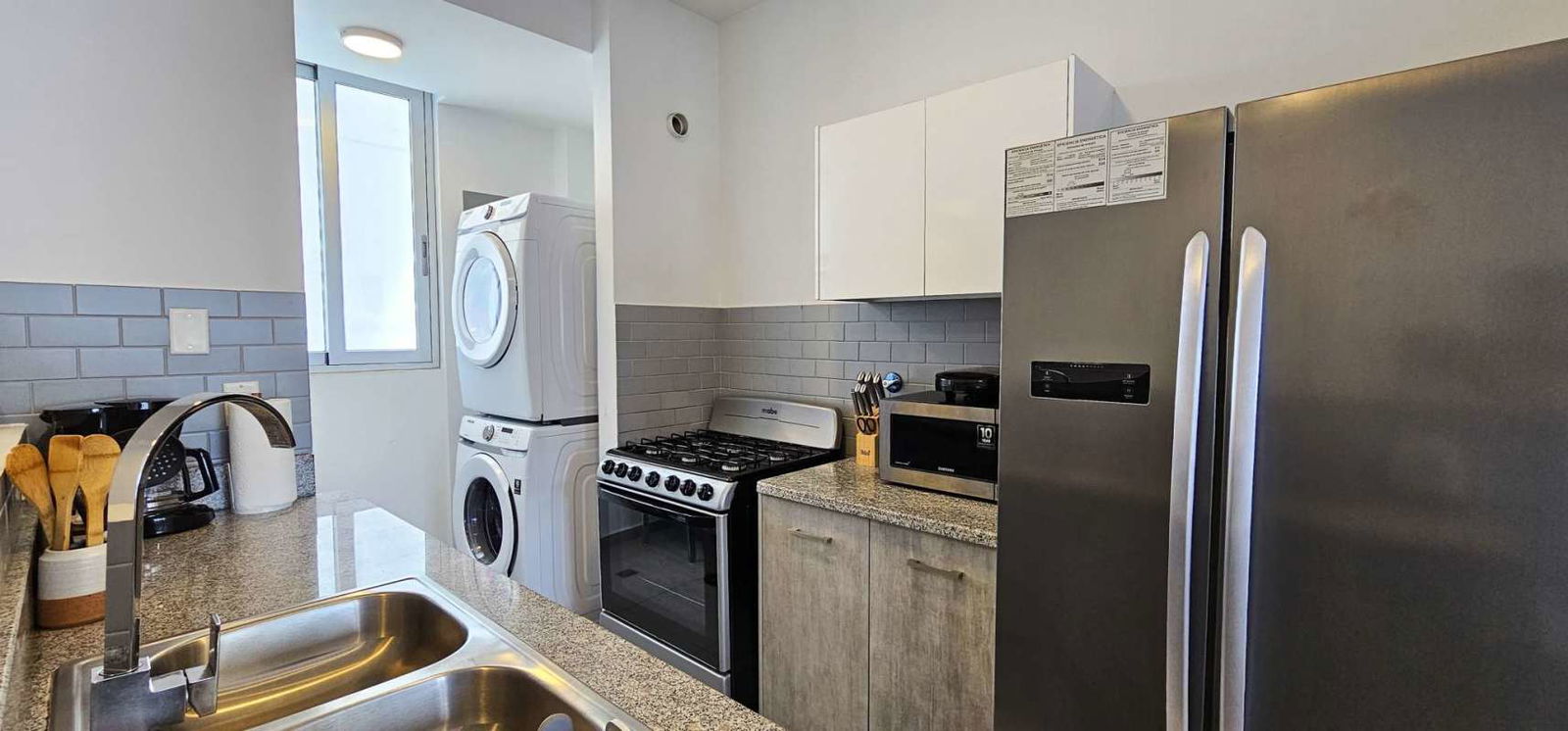 Furnished living and dining room with large windows, city view in PH Signature Point Avenida Balboa Panama