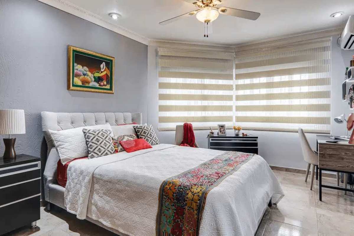 Bright bedroom with large windows, ensuite bathroom, and city views in luxury house Dos Mares Panama