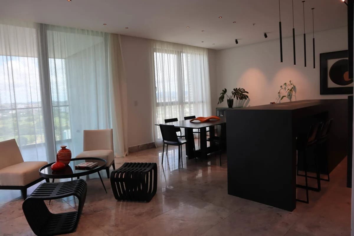 Open-plan living and dining room with marble floors, golf course views at PH Empire Santa María Panama