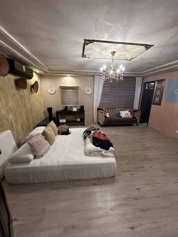 Traditional kitchen in corner house Altos de Panama with island granite countertops and wood cabinets