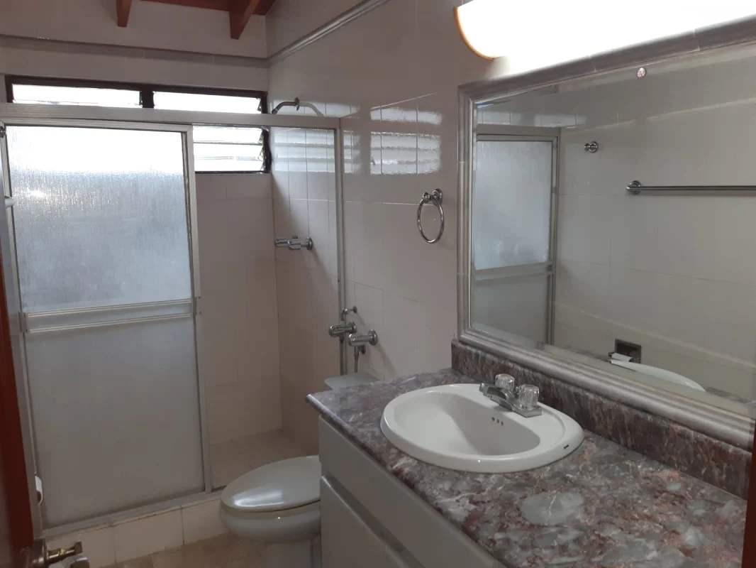 Modern traditional bathroom with marble counters and frosted glass shower PH Torres de Toscana Panama