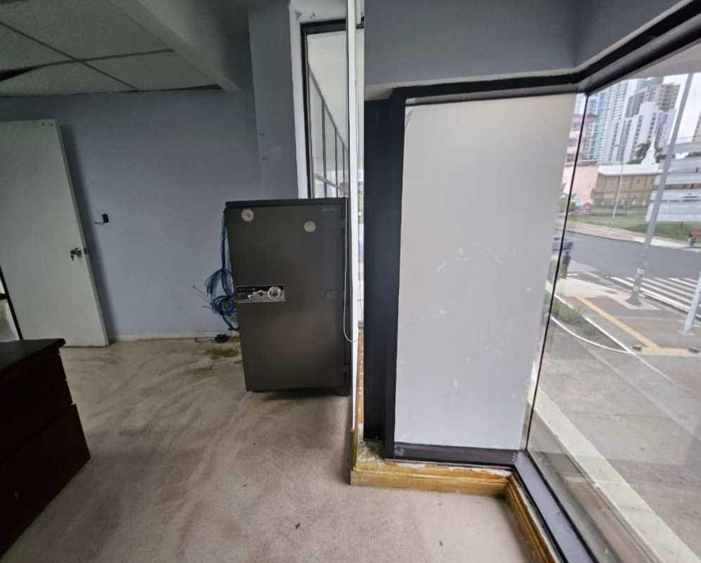 Unfurnished office interior with natural lighting, large windows overlooking city Panama Bella Vista