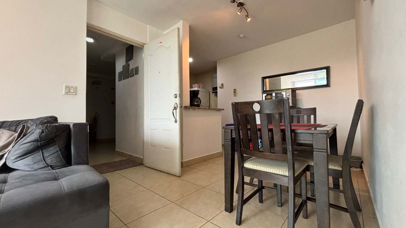Dining area with sectional sofa, pass-through kitchen and tile floors PH Albrook Point