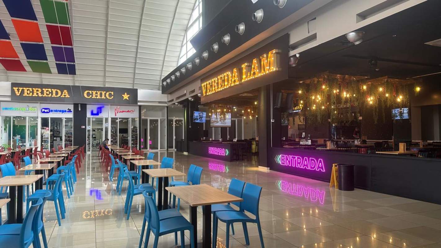 Vaulted ceiling, colorful seating, neon signage dining area Los Andes Mall Rufina Alfaro Panama