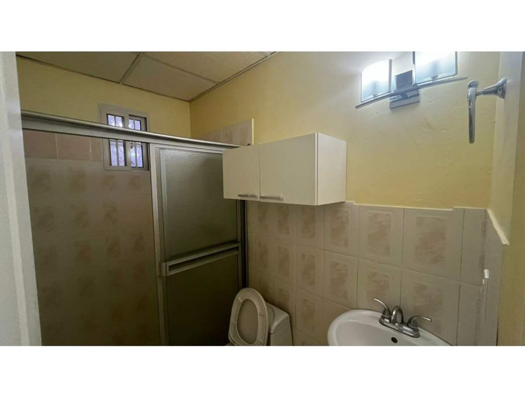 Bathroom with sliding glass door tiled walls window in Camino Real Brisas del Golf Panama