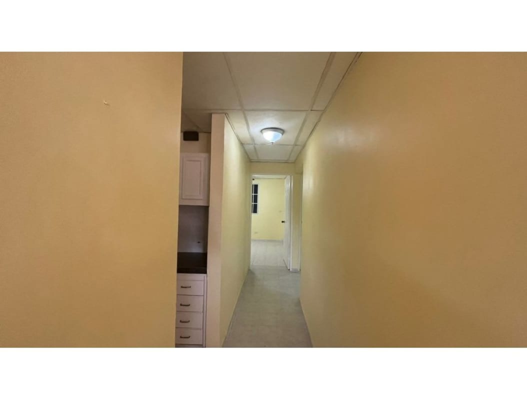 Open living room area with ceramic floors ceiling fan yellow wall in Camino Real Brisas del Golf Panama