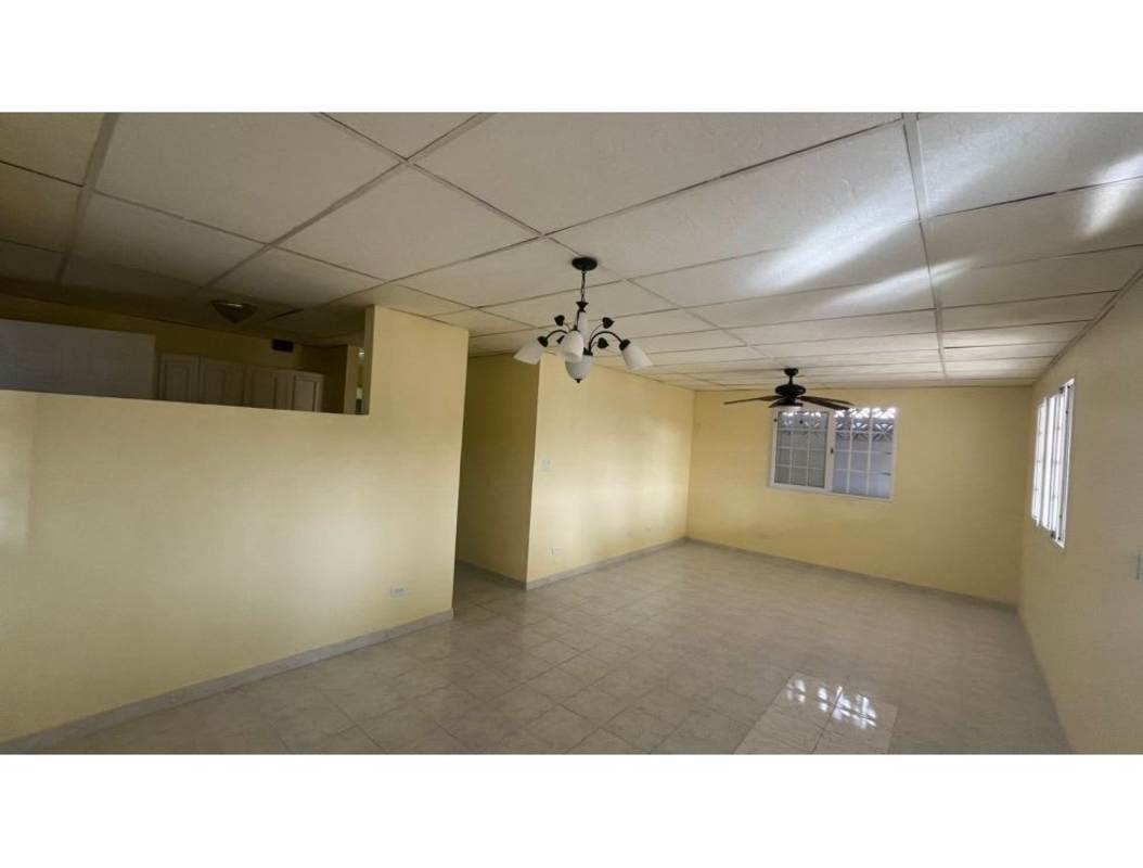 Basic kitchen with cabinetry, vent hood, tiled walls floor in Camino Real San Antonio Panama