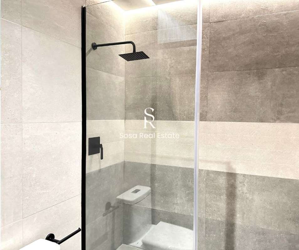 Luxury minimalist bathroom with rainfall glass shower in Uptown Condo Marbella Panama