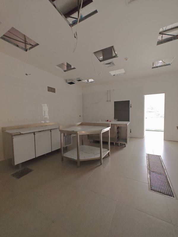 Commercial utility kitchen space with stainless steel worktable and tiled floor in Panama City