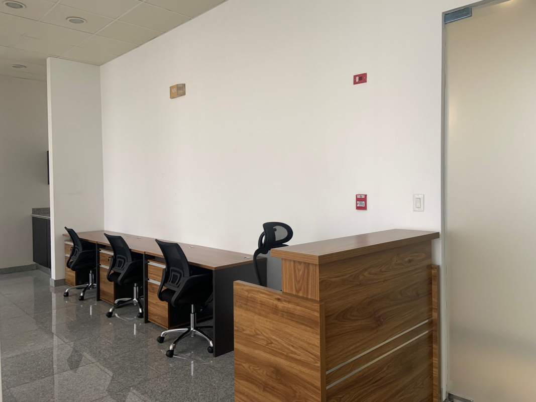 Reception counter with multiple workstations black chairs in PH Bella Vista Office Center