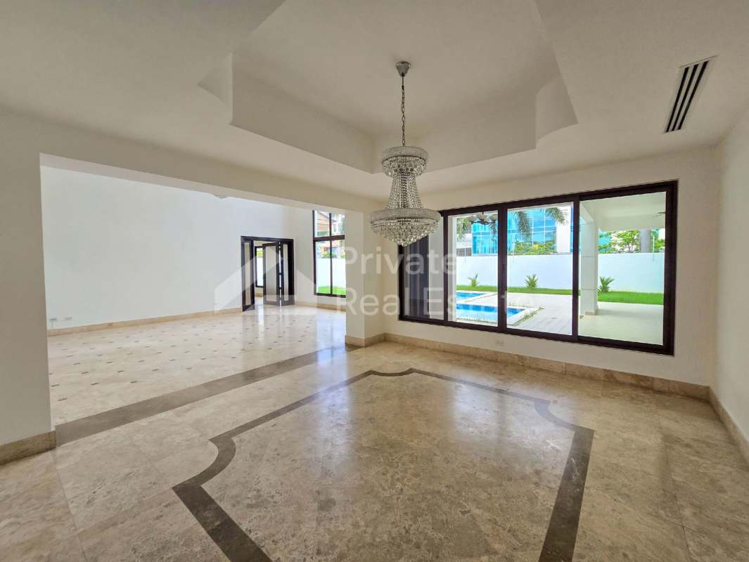 Contemporary kitchen with granite island, wood cabinetry and large windows Costa del Este Panama