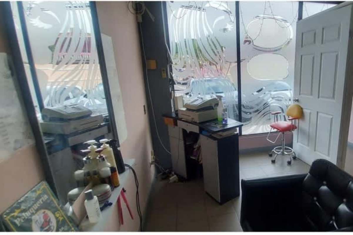 Reception counter and retail display shelves in commercial beauty salon Condado Plaza Condado del Rey