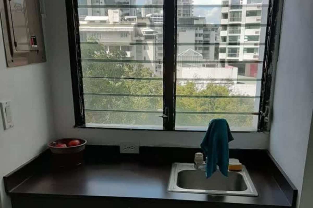 Commercial bathroom with tiled walls, sink, mirror PH Financial Park Panama City