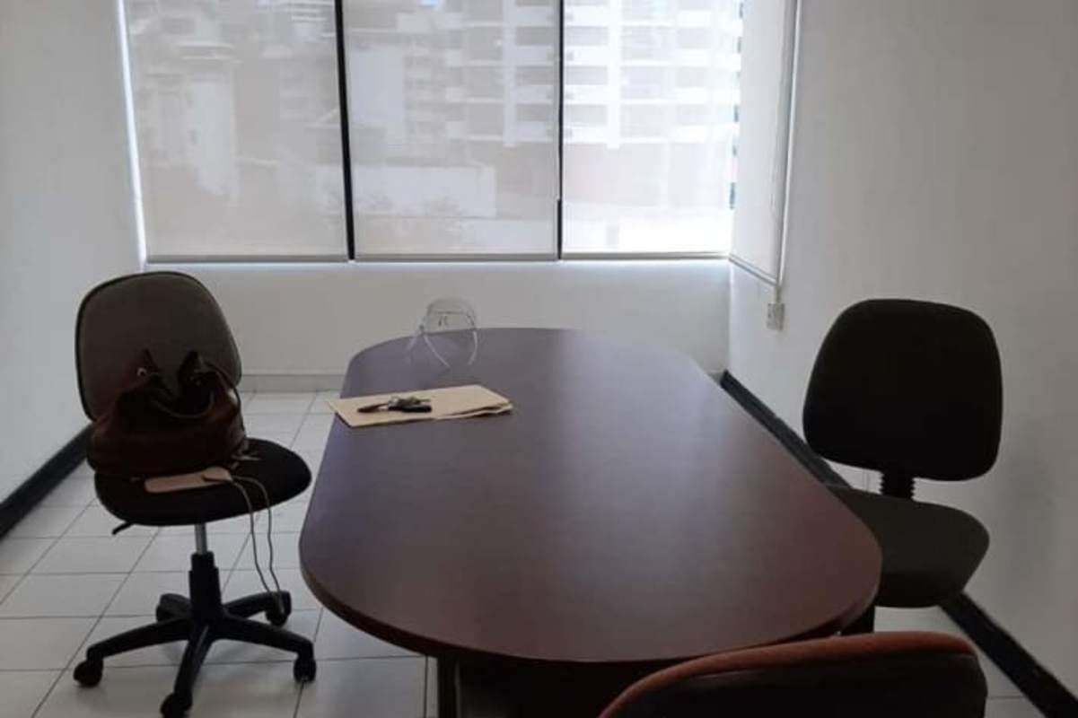 Simple office meeting room with glass divider, table and chairs in Calle 50 Financial District Panama