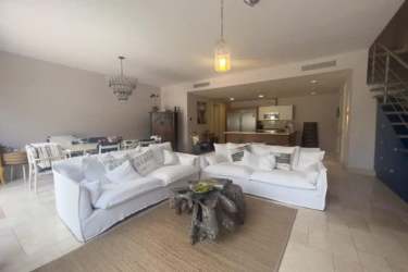 Bright living room opens to terrace with garden views in Buenaventura Resort Panama