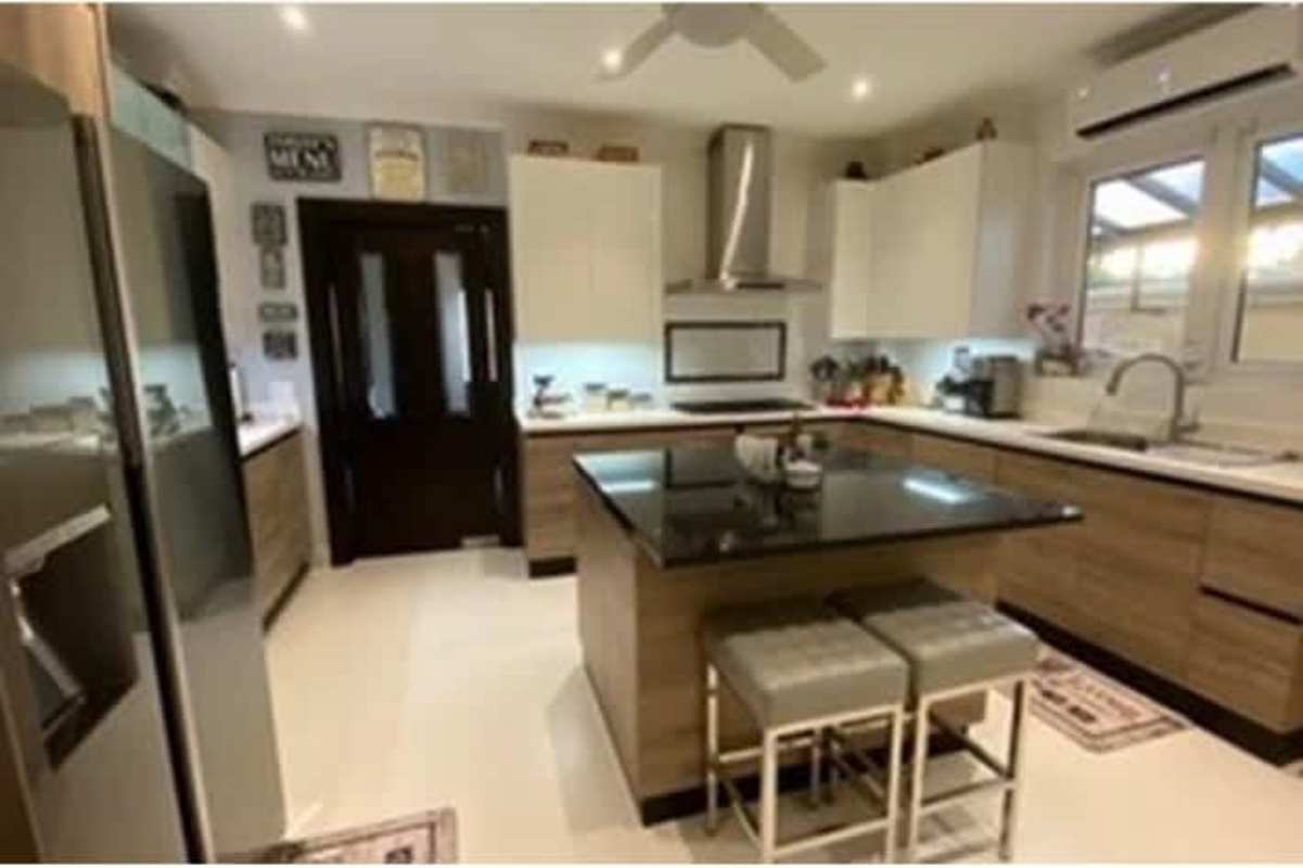 Spacious master bedroom with balcony, split AC, large windows and elegant furnishings at Rainforest Villas Betania Panama