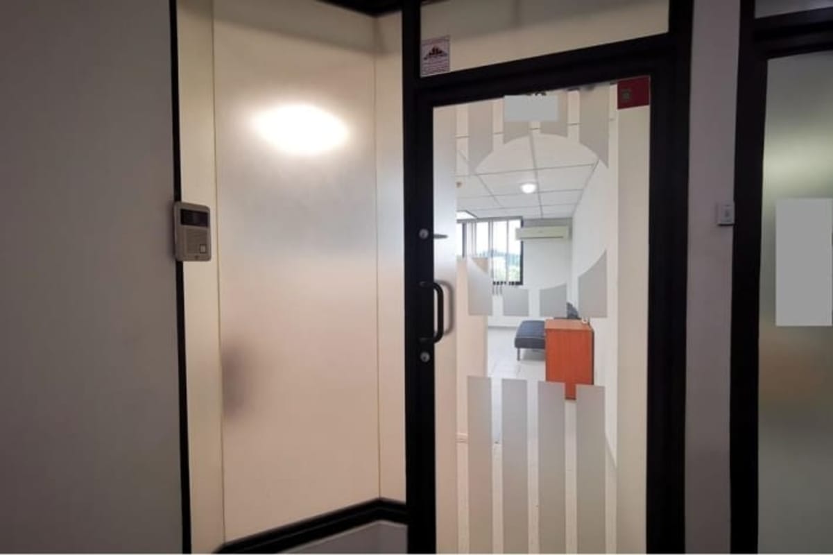 Office entry with frosted glass partitions, security door, reception inside El Cangrejo Panama
