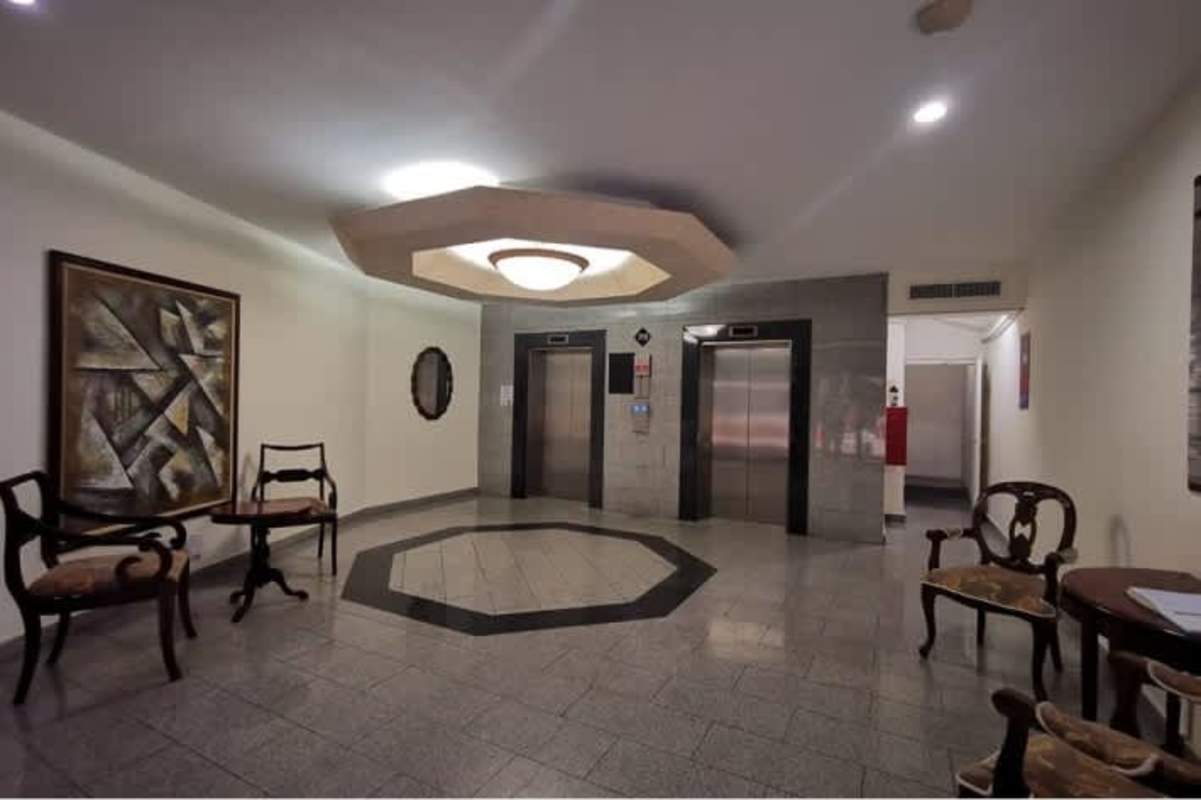 Lobby area with elevators, seating, geometric lighting at International Business Center Panama