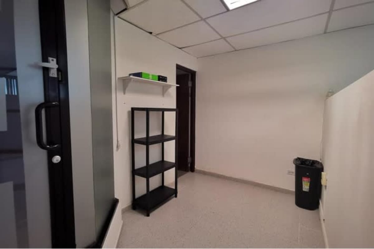 Minimalist office with glass door, white walls, El Cangrejo business hub Panama