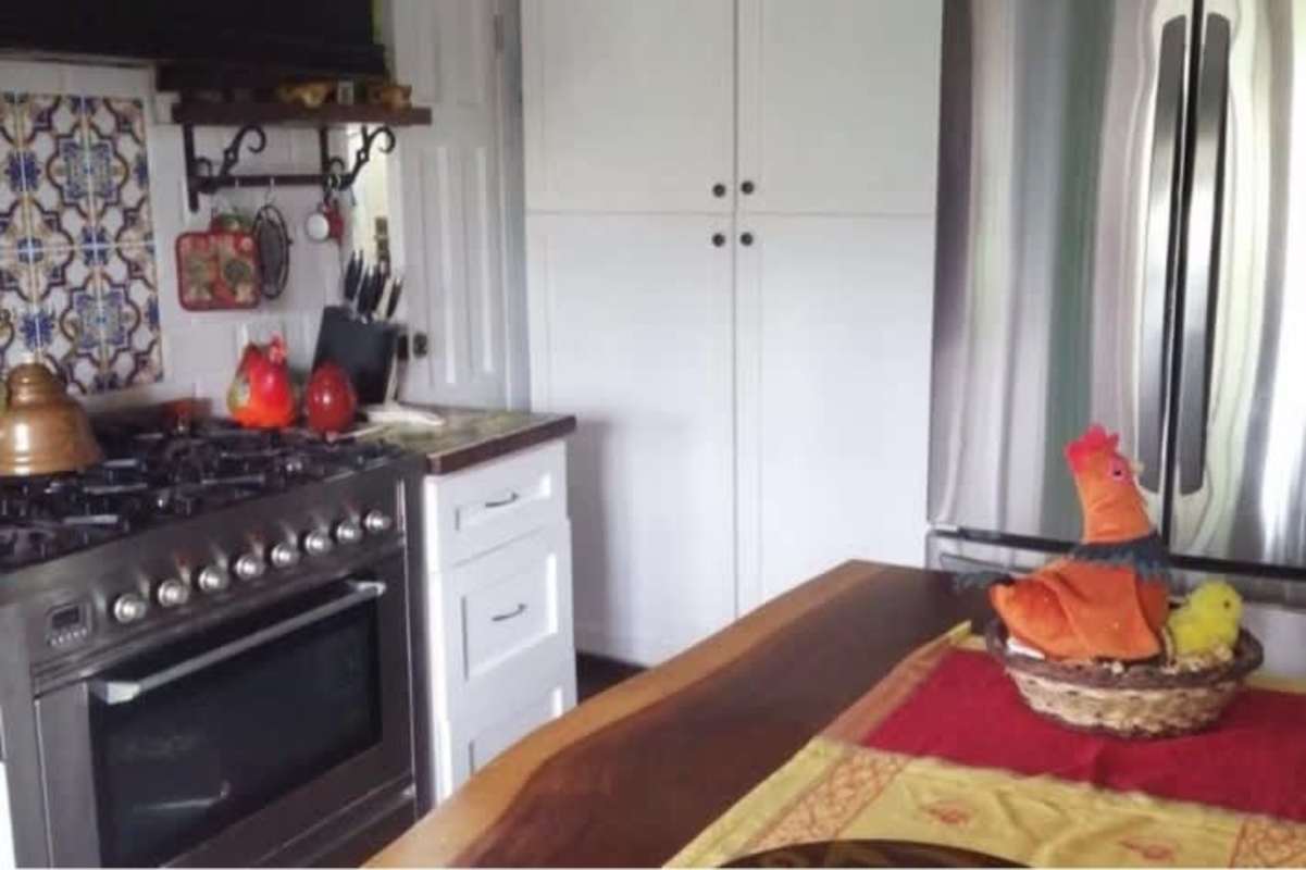 Country kitchen with stainless appliances, wood counters, decorative backsplash in Altos de Cerro Azul Panama