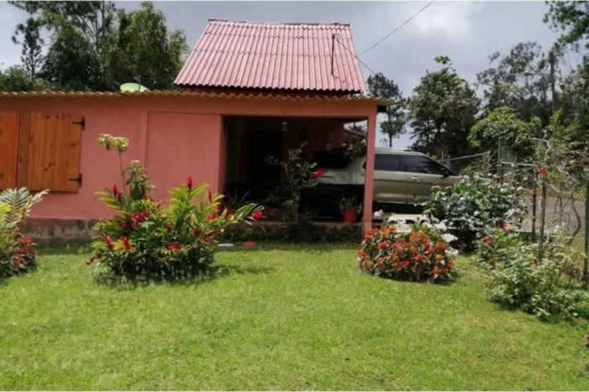 Red two-story house with metal roof, fenced yard, carport Altos de Cerro Azul Panama