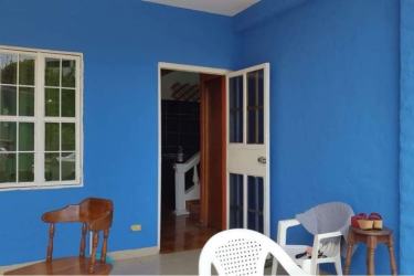 Bright green hallway with window and white railing beachfront house Playa Farallón Panama