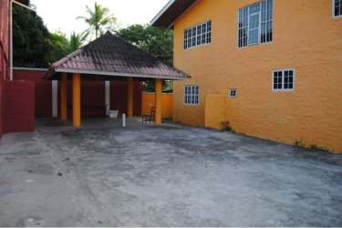 Exterior with orange walls, covered tiled patio, spacious courtyard by Playa Farallón beachfront home