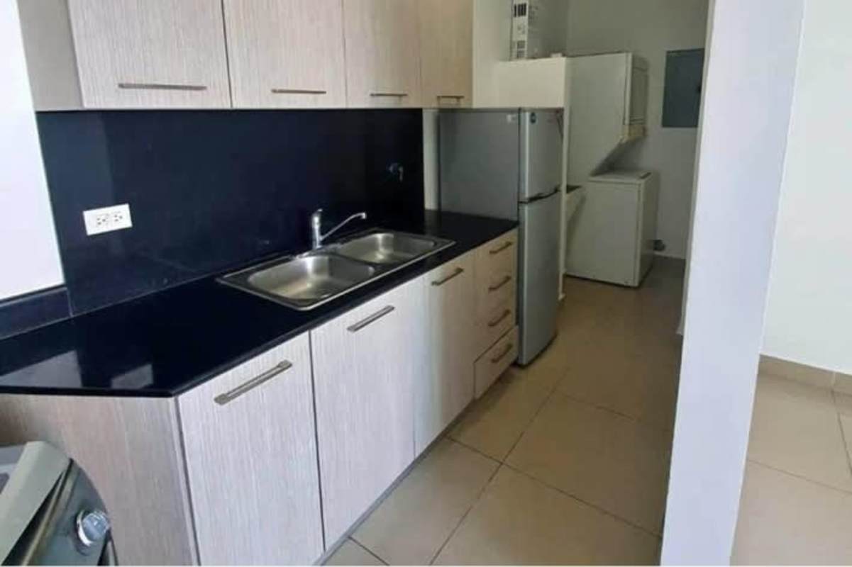 Kitchen black countertop upper cabinets laundry area PH Green Park Panama