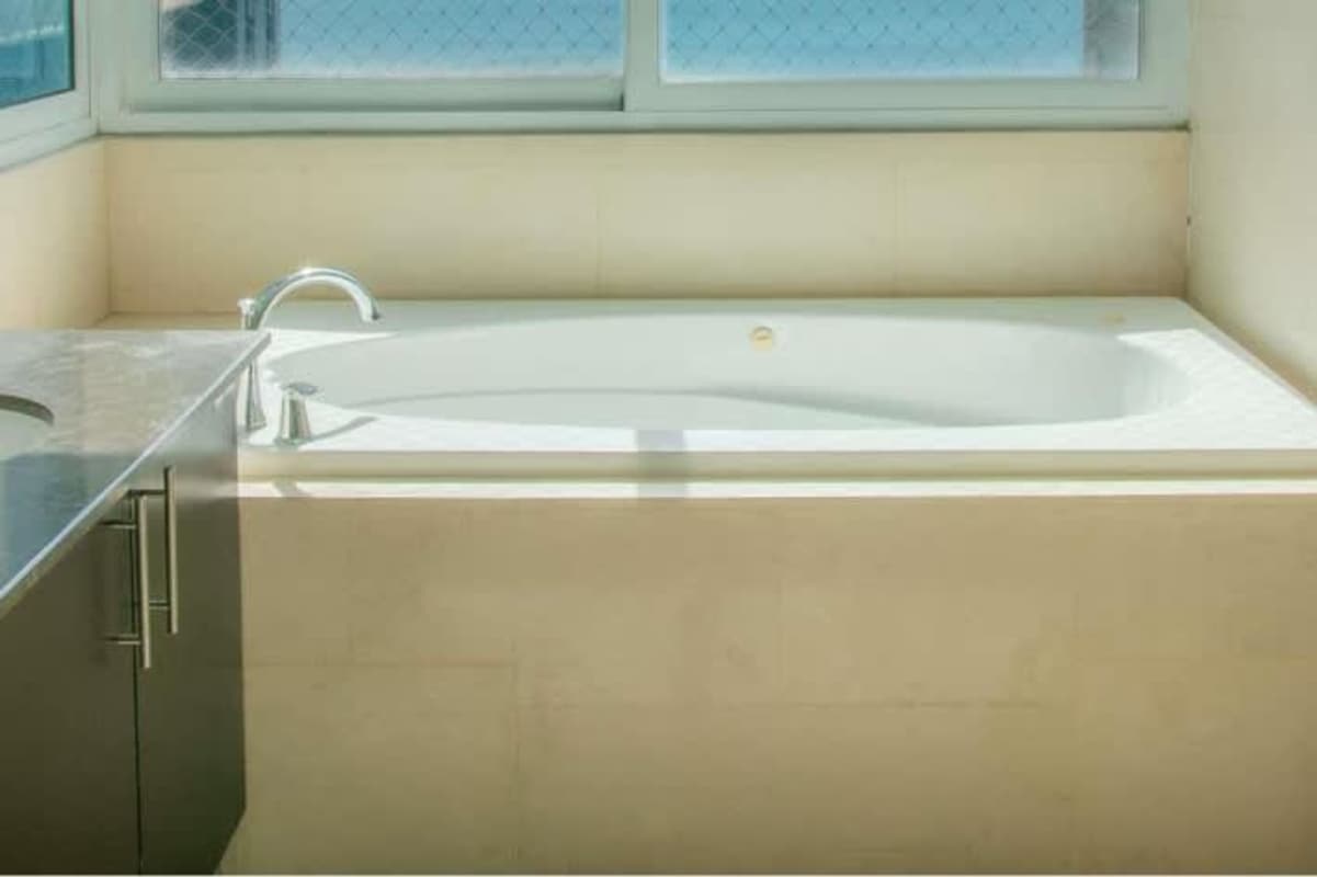 Elegant bedroom with built-in closets and ocean view window in The Point Panama City