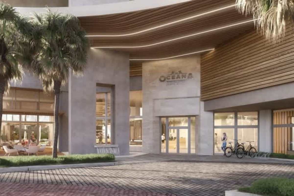 Modern lobby entrance with glass walls, wood ceilings, palm trees, outdoor lounge PH Oceana Santa Maria